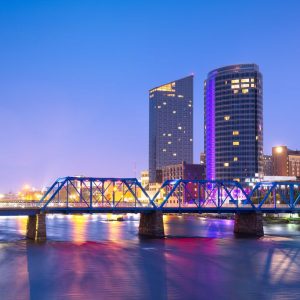 Grand Rapids, Michigan, USA downtown skyline on the Grand River at dusk.