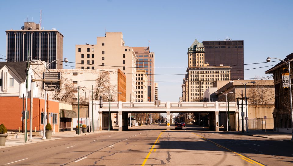 The streets and buildings of Dayton, Ohio only have a few travelers early Sunday morning