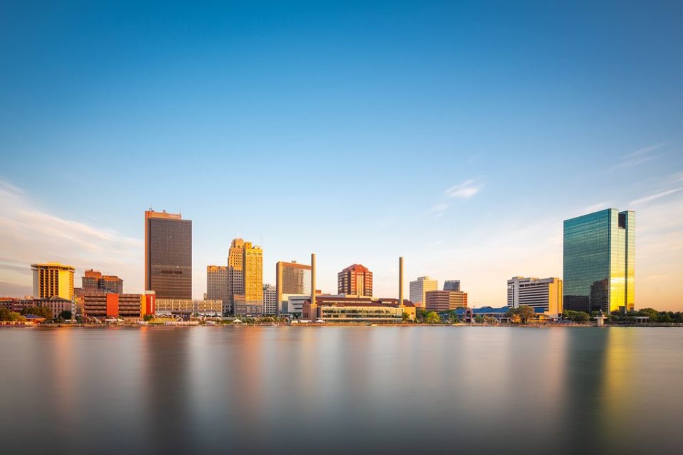 Toledo, Ohio, USA downtown skyline on the Maumee River at dusk.