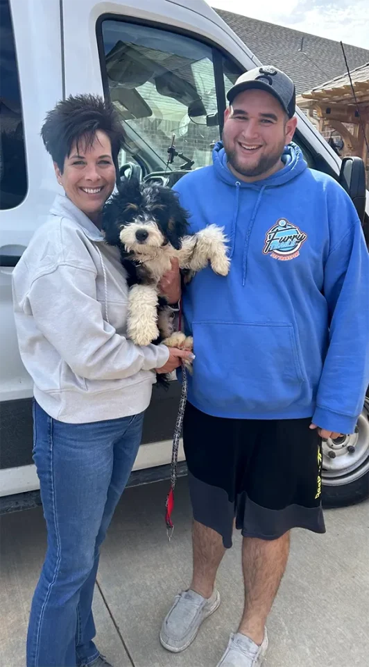 Happy Lady Holding Puppy, With Furry Trails Delivery Driver