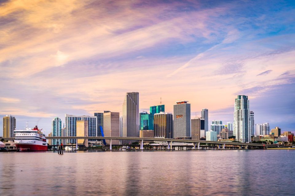 Miami, Florida City Skyline From The Water With Bridge And Cruise Ship